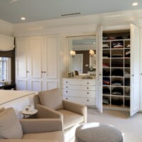 Furnished master bedroom with closet doors open